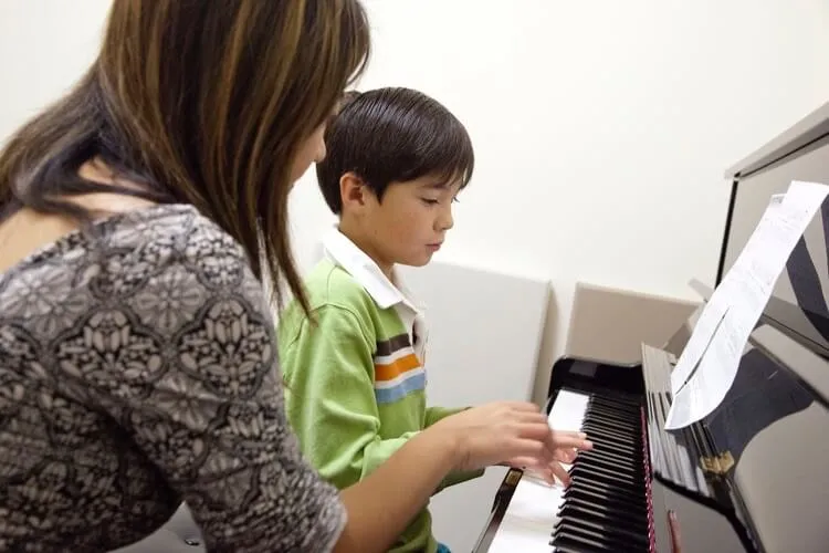 Child taking a piano lesson at Opus 1 Music Studio